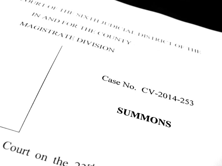 A close-up of a legal summons document showing the case number CV-2014-253 and the word SUMMONS in bold.
