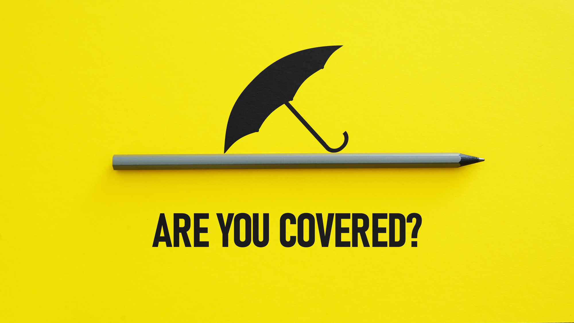 A black umbrella graphic above a gray pencil on a yellow background with the text ARE YOU COVERED? written below.